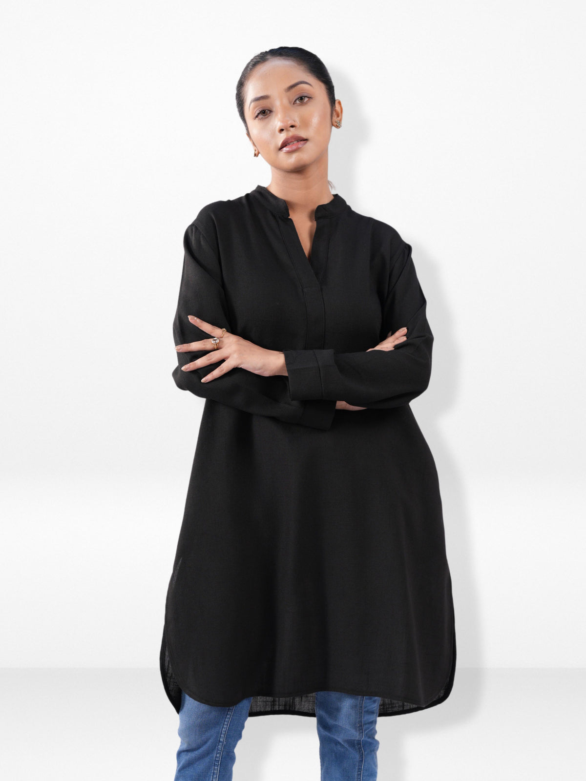 Woman wearing a black long-sleeve top with a white background