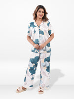 Woman wearing a floral pajama set on a white background