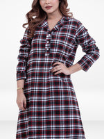 Woman wearing a plaid dress with a white background