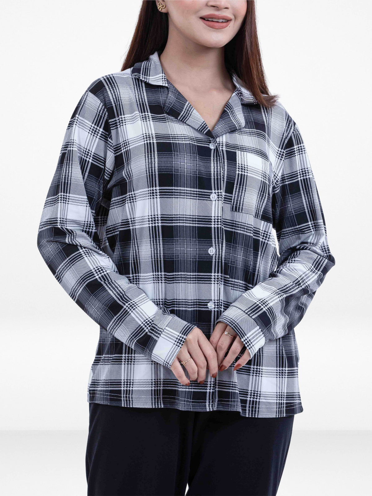 Person wearing a black and white plaid shirt on a white background