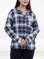 Person wearing a black and white plaid shirt on a white background
