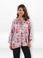 Woman wearing a floral blouse on a white background