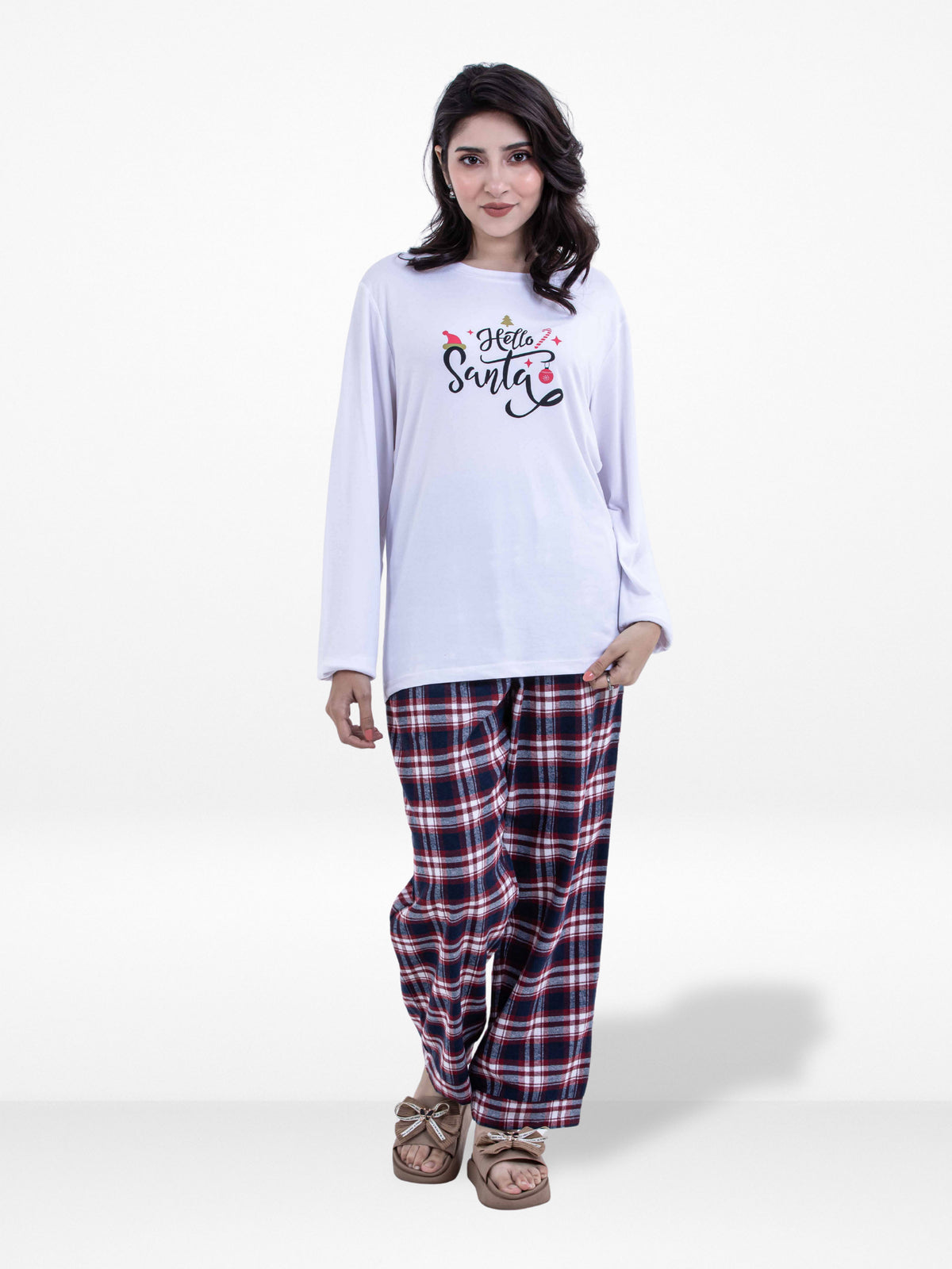 Woman wearing a white 'Hello Santa' shirt and plaid pants on a white background