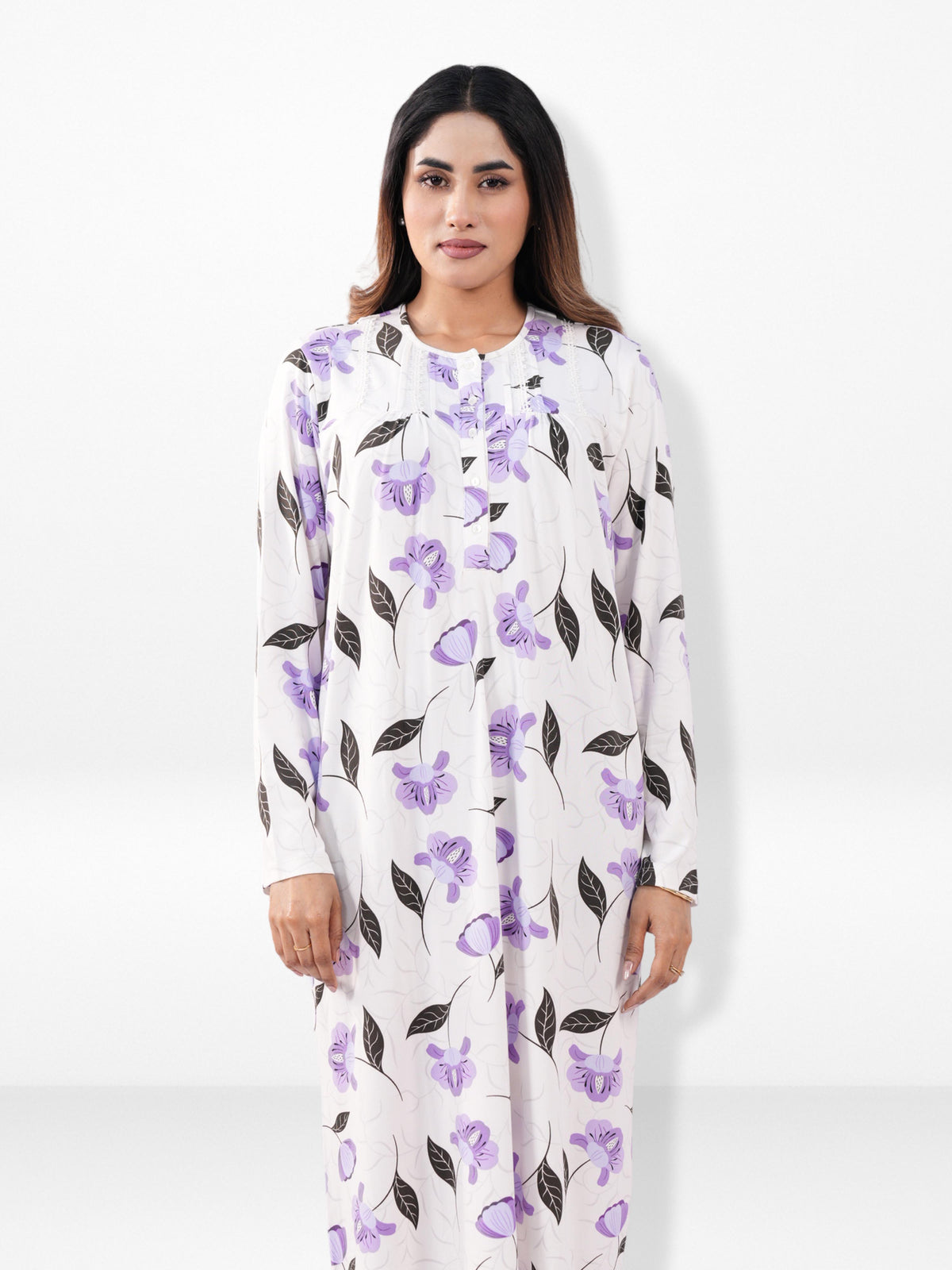Woman wearing a white nightgown with purple floral pattern on a white background