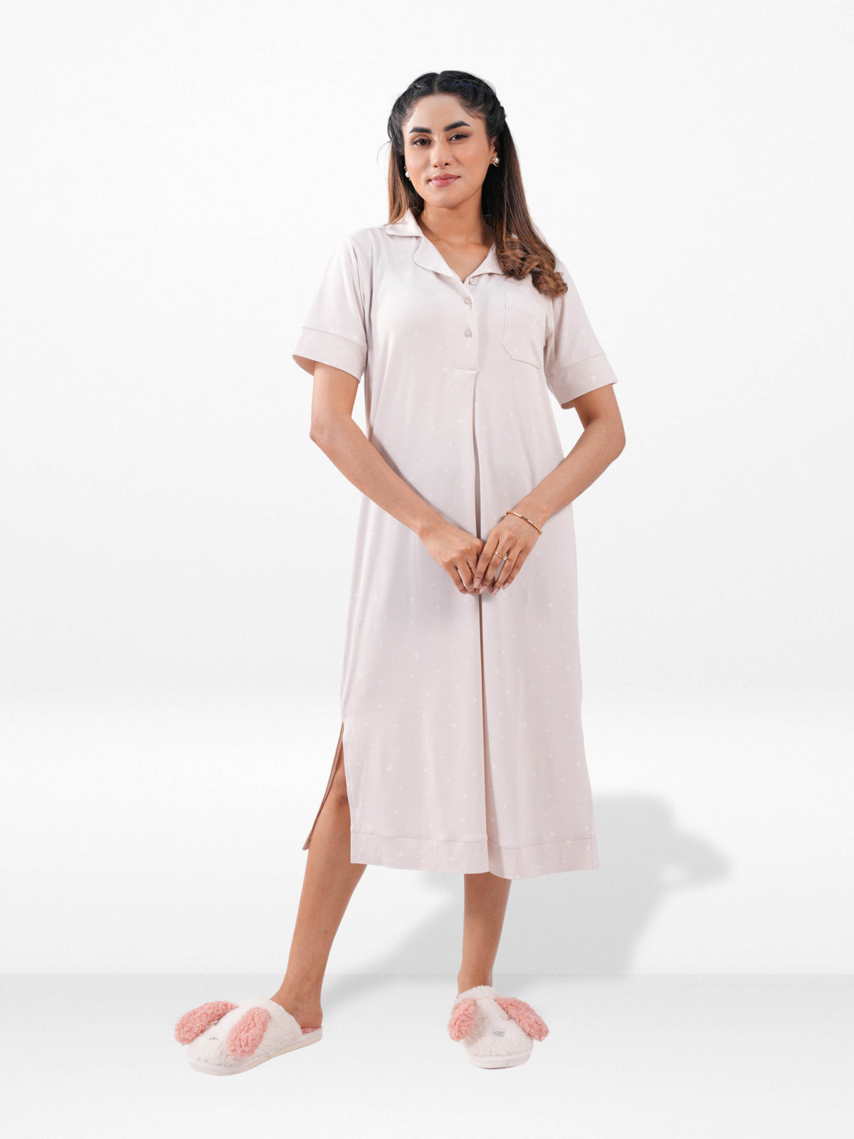 Woman wearing a white dress with a button-up front on a white background