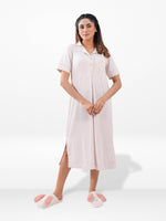 Woman wearing a white dress with a button-up front on a white background