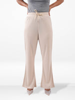 Beige wide-leg pants worn by a person on a white background