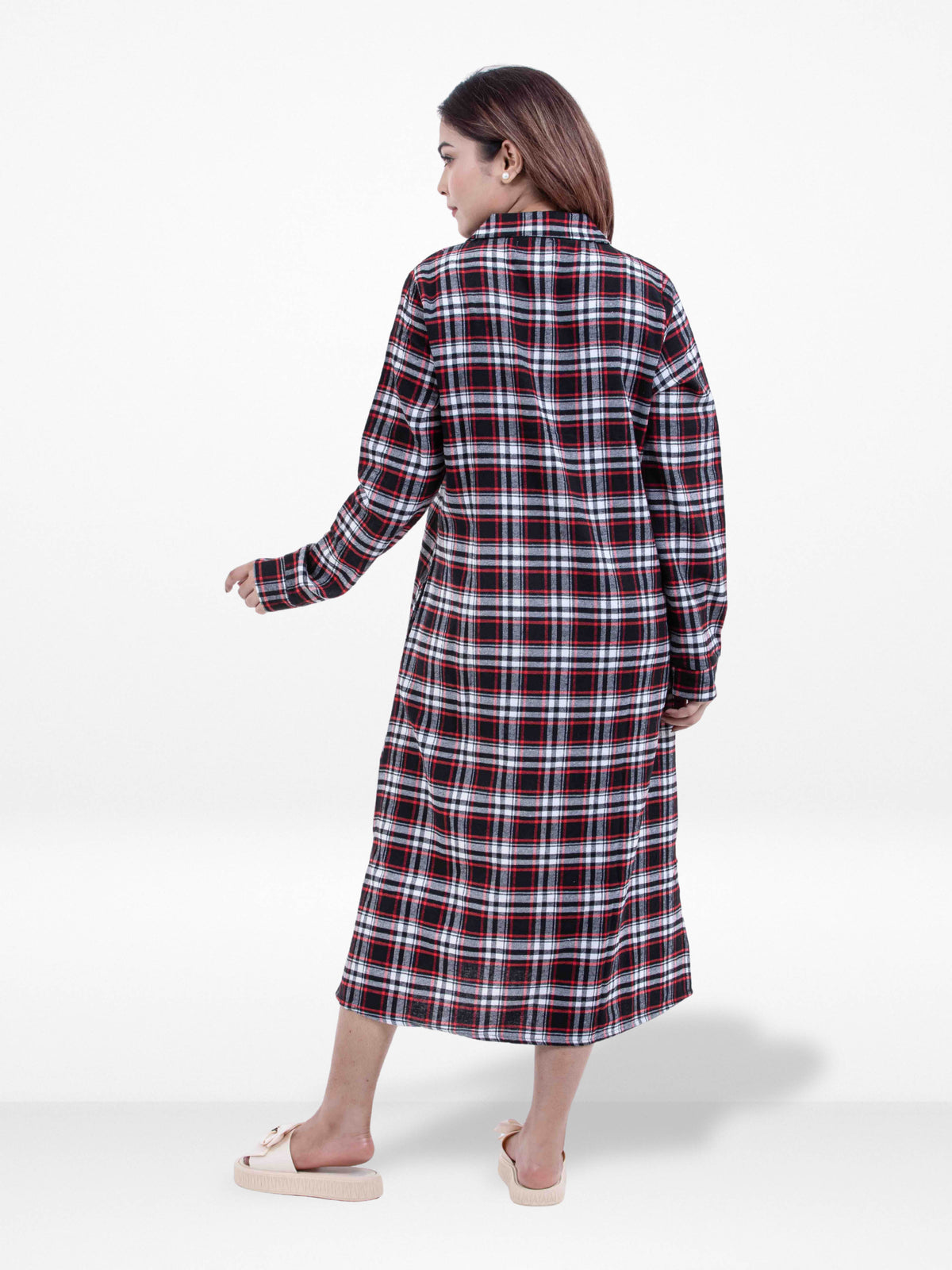 Woman wearing a red and black plaid dress on a white background