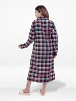 Woman wearing a red and black plaid dress on a white background