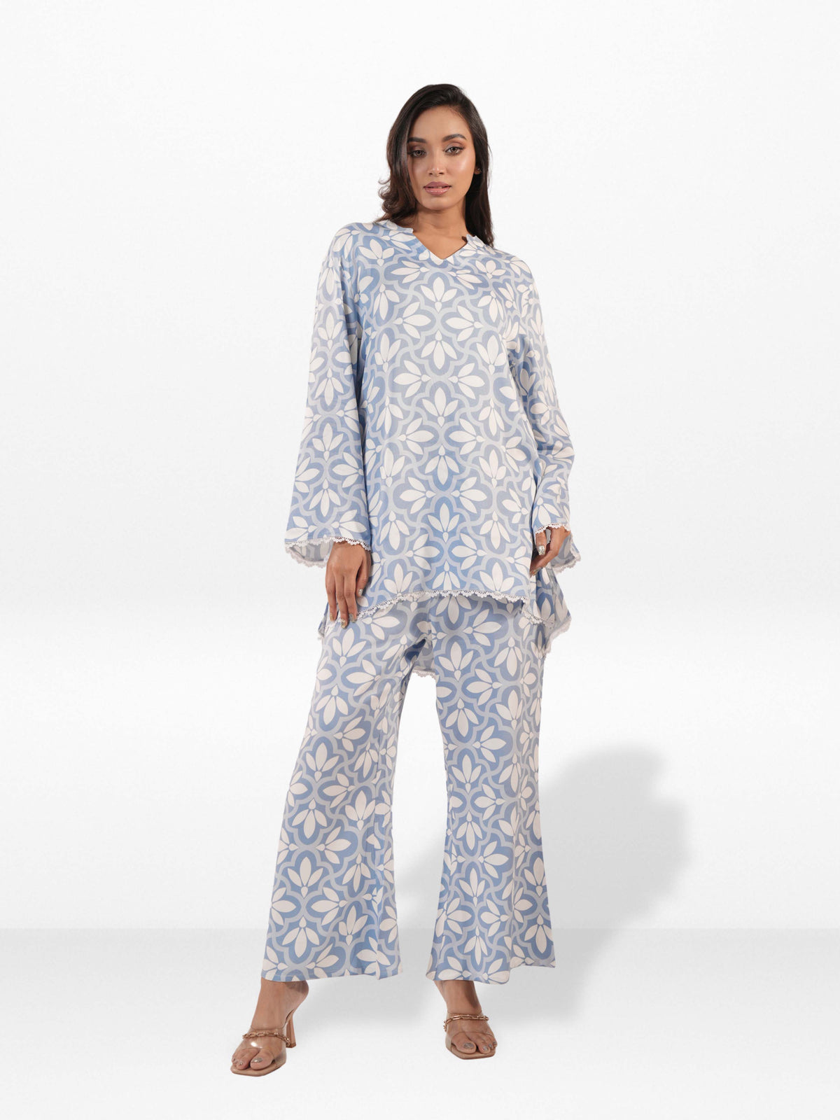 Woman wearing a blue and white patterned outfit on a white background