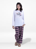 Woman wearing a white 'Hello Santa' shirt and plaid pants on a white background