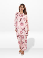 Woman wearing a pink floral outfit on a white background